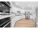 Bright kitchen with modern stainless steel appliances, white cabinets, a center island, and stylish lighting at 307 Cochin Dr, Woodstock, GA 30188
