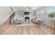Bright living room with a fireplace, built-in shelves, staircase, and comfortable seating arrangement at 307 Cochin Dr, Woodstock, GA 30188