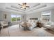Spacious main bedroom boasts a trey ceiling, large windows, and neutral decor at 307 Cochin Dr, Woodstock, GA 30188