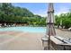 Community pool with lounge chairs and umbrellas offer a resort-like feel at 307 Cochin Dr, Woodstock, GA 30188