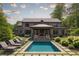 A picturesque pool with lounge chairs surrounded by lush landscaping in a private backyard creating a serene retreat at 3338 Breton Ne Cir, Brookhaven, GA 30319