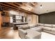 Finished basement with a large sectional sofa, bar area with countertops, and exposed ceiling at 3338 Breton Ne Cir, Brookhaven, GA 30319