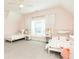 Charming bedroom features two twin beds, light pink walls, carpet and ceiling fan at 3338 Breton Ne Cir, Brookhaven, GA 30319