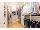 Large walk-in closet with wood floor and custom shelving and racks for optimal storage solutions at 3338 Breton Ne Cir, Brookhaven, GA 30319