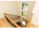 Elegant staircase with wooden railings, black iron balusters, and abundant natural light streaming through large windows at 3338 Breton Ne Cir, Brookhaven, GA 30319