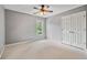 Bedroom with neutral-colored walls, neutral decor, natural lighting, and large closets at 4915 Lazy Creek Ct, Cumming, GA 30028
