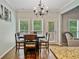 Breakfast nook and hardwood floors with wooded view at 4915 Lazy Creek Ct, Cumming, GA 30028