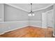 Dining area featuring a chandelier, hardwood floors, neutral walls, and white trim at 4915 Lazy Creek Ct, Cumming, GA 30028