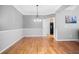 Spacious dining room with hardwood floors, chandelier, and wainscoting at 4915 Lazy Creek Ct, Cumming, GA 30028