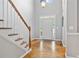 Bright foyer with hardwood floors, staircase, and a view of the front door at 4915 Lazy Creek Ct, Cumming, GA 30028