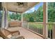 Inviting covered front porch with a wooden swing, ceiling fan and comfortable seating at 4915 Lazy Creek Ct, Cumming, GA 30028