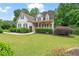 Charming two-story home featuring a landscaped front yard, covered porch, and appealing curb appeal at 4915 Lazy Creek Ct, Cumming, GA 30028