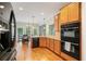 Kitchen featuring a double oven, black dishwasher, and breakfast nook at 4915 Lazy Creek Ct, Cumming, GA 30028