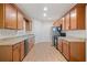 Well-lit kitchen with wooden cabinets, granite countertops, stainless steel appliances, and hardwood floors at 4915 Lazy Creek Ct, Cumming, GA 30028