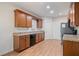 Well-lit kitchen featuring wooden cabinets, granite countertops, stainless steel appliances, and hardwood floors at 4915 Lazy Creek Ct, Cumming, GA 30028