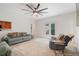 Spacious living room with plush seating, large ceiling fan, and access to a deck through glass doors at 4915 Lazy Creek Ct, Cumming, GA 30028