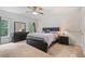 Inviting bedroom features a large bed with an elegant dark wood frame, a ceiling fan, and soft, natural light at 4915 Lazy Creek Ct, Cumming, GA 30028