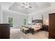 This main bedroom features natural lighting, a decorative ceiling, and neutral decor at 4915 Lazy Creek Ct, Cumming, GA 30028