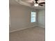 Serene bedroom with soft carpeting, a ceiling fan, and a window for plenty of natural light at 1221 St James Pl, Loganville, GA 30052