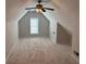 Spacious and carpeted bonus room features a ceiling fan and a bright window at 1221 St James Pl, Loganville, GA 30052