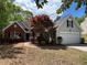 Charming home with a brick and vinyl exterior, complemented by a well-manicured lawn and mature landscaping at 1221 St James Pl, Loganville, GA 30052