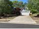 Charming home featuring a two-car garage and well-manicured landscaping at 1221 St James Pl, Loganville, GA 30052
