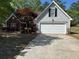 Charming home featuring a two-car garage and well-manicured landscaping at 1221 St James Pl, Loganville, GA 30052