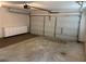 Spacious garage with overhead door and cabinets for organized storage at 1221 St James Pl, Loganville, GA 30052
