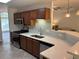 Eat-in kitchen boasts stainless steel appliances, modern countertops and cabinets, plus a view to the living room at 1221 St James Pl, Loganville, GA 30052