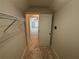 Walk-in closet with carpet, wire shelving, and view to bonus room at 1221 St James Pl, Loganville, GA 30052