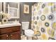 Cozy bathroom featuring patterned shower curtain, wood vanity, and decorative accents at 230 Haleys Ct, Woodstock, GA 30188