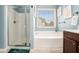 Bathroom with glass-enclosed shower, soaking tub, and updated fixtures at 230 Haleys Ct, Woodstock, GA 30188