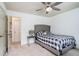 Bedroom with a ceiling fan, bed with tufted headboard, and access to hall at 230 Haleys Ct, Woodstock, GA 30188