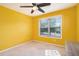 Bright bedroom features a ceiling fan and a window providing natural light at 230 Haleys Ct, Woodstock, GA 30188