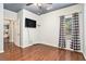 Bright bedroom with wood floors, neutral paint, and a window with stylish curtains at 230 Haleys Ct, Woodstock, GA 30188