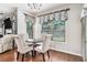Inviting breakfast nook with hardwood floors, chandelier, and window overlooking the backyard at 230 Haleys Ct, Woodstock, GA 30188