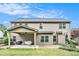 Back exterior featuring large yard with covered patio and space for activities at 230 Haleys Ct, Woodstock, GA 30188