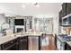 Bright kitchen with granite countertops, stainless steel appliances, and an open view to the living spaces at 230 Haleys Ct, Woodstock, GA 30188