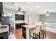 Modern kitchen featuring granite countertops, black cabinets, stainless steel appliances, and an island with bar seating at 230 Haleys Ct, Woodstock, GA 30188