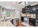 Well-equipped kitchen with stainless steel appliances, granite countertops, and dark cabinetry at 230 Haleys Ct, Woodstock, GA 30188