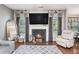 Comfortable living room featuring a fireplace, large windows, hardwood floors, and cozy furniture at 230 Haleys Ct, Woodstock, GA 30188
