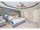 Elegant main bedroom with tray ceiling, sitting area, and decorative wall accents at 230 Haleys Ct, Woodstock, GA 30188