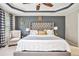 Main bedroom with tray ceiling, stylish decor, and large windows for natural light at 230 Haleys Ct, Woodstock, GA 30188