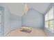 Bright bedroom with a vaulted ceiling, modern light fixture, and large window at 2584 Grayton Loop, Villa Rica, GA 30180