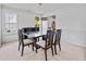Elegant dining room with modern chandelier, large windows, and neutral decor at 2584 Grayton Loop, Villa Rica, GA 30180