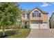 Beautiful two-story home with a well-manicured lawn, complemented by a paved driveway and lush landscaping at 2584 Grayton Loop, Villa Rica, GA 30180