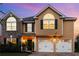 Charming two-story home with a two-car garage and inviting curb appeal against a vibrant sunset at 2584 Grayton Loop, Villa Rica, GA 30180