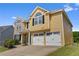 Inviting two-story home featuring a convenient two-car garage and a freshly manicured lawn at 2584 Grayton Loop, Villa Rica, GA 30180