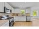 Modern kitchen featuring white cabinets, stainless steel appliances, and granite countertops at 2584 Grayton Loop, Villa Rica, GA 30180