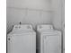 Clean laundry room with washer, dryer, and a wire shelf at 2584 Grayton Loop, Villa Rica, GA 30180